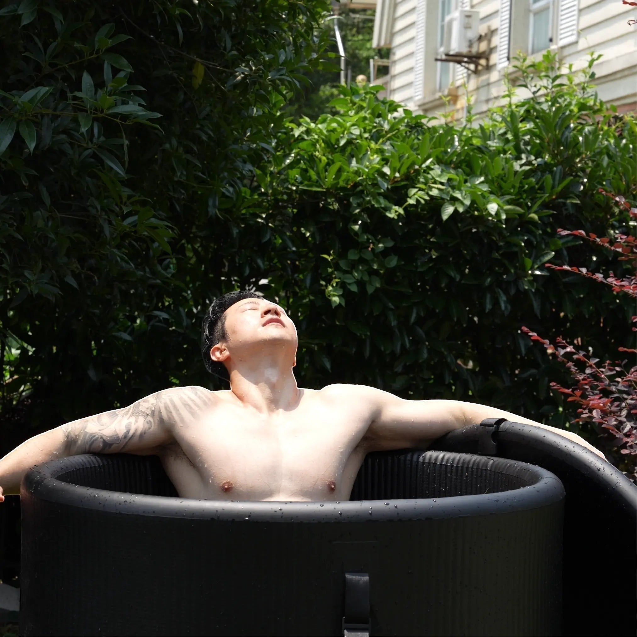 Garvnive Black Inflatable Ice Bath Tub, featuring a textured PVC design, suitable for indoor and outdoor use.